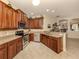 Well-lit kitchen with wood cabinetry, stainless steel appliances, and neutral countertops at 29692 Niagara Ct, Englewood, FL 34223