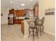 Bright eat-in kitchen with stainless steel refrigerator, tile floors, and breakfast bar at 29692 Niagara Ct, Englewood, FL 34223