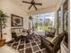 Relaxing screened lanai with comfortable seating and scenic views of the lush backyard at 29692 Niagara Ct, Englewood, FL 34223