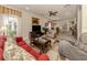 Spacious living room with tiled floors and an open concept view of the dining area at 29692 Niagara Ct, Englewood, FL 34223