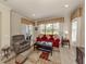 Comfortable living room with a large window, patterned rug, and sliding glass doors to patio at 29692 Niagara Ct, Englewood, FL 34223