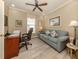 Comfortable office space with a ceiling fan and a work desk area with a sofa at 29692 Niagara Ct, Englewood, FL 34223