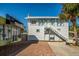 Two-story building with a storefront, stairway to the second floor and brick patio at 29692 Niagara Ct, Englewood, FL 34223
