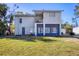 Two-story home with a balcony and neutral color scheme, complemented by a well-kept green lawn at 3052 Alta Vista St, Sarasota, FL 34237