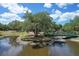 Charming bridge over a pond surrounded by mature trees and lush landscaping, creating a peaceful setting at 3052 Alta Vista St, Sarasota, FL 34237