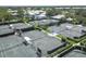 Aerial view of community tennis courts and aquatic center, nestled amongst ponds and beautiful tropical landscaping at 311 Pembroke Dr # 217, Venice, FL 34293