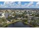 Aerial view of the home nestled beside a lake, with surrounding community and lush greenery at 311 Pembroke Dr # 217, Venice, FL 34293