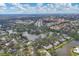 Aerial view of the home surrounded by lush trees, a lake, and a beautiful neighborhood at 311 Pembroke Dr # 217, Venice, FL 34293