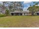 Spacious backyard with well-maintained lawn and a view of the home's screened-in lanai at 311 Pembroke Dr # 217, Venice, FL 34293