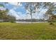 Expansive backyard with green grass and serene lake views, perfect for outdoor enjoyment at 311 Pembroke Dr # 217, Venice, FL 34293