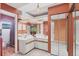 Bright bathroom featuring double vanity, mirrored closet doors, and a separate toilet and shower area at 311 Pembroke Dr # 217, Venice, FL 34293