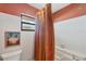 Bathroom featuring a shower and tub with a striped curtain and a small window at 311 Pembroke Dr # 217, Venice, FL 34293