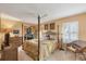 This main bedroom suite features a four poster bed, neutral decor, and a private terrace entry at 311 Pembroke Dr # 217, Venice, FL 34293