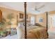 This main bedroom suite features a four poster bed, neutral decor, and ensuite bathroom at 311 Pembroke Dr # 217, Venice, FL 34293