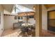 Cozy patio with a dining set, umbrella, and outdoor grill for entertaining at 311 Pembroke Dr # 217, Venice, FL 34293