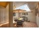 Private patio with a dining table, umbrella, and outdoor grill at 311 Pembroke Dr # 217, Venice, FL 34293