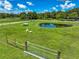 Picturesque pasture with a tranquil pond, complemented by grazing animals and sturdy fencing at 35960 State Road 70 E, Myakka City, FL 34251