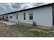 Spacious backyard featuring well-maintained lawn, gravel landscaping and mature trees at 404 Elder St # 230, Englewood, FL 34223