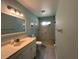 Bathroom featuring a glass enclosed shower with a seat and single sink vanity at 404 Elder St # 230, Englewood, FL 34223