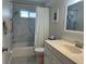 Bright bathroom featuring a shower-tub combo with a white marble-tiled backsplash at 404 Elder St # 230, Englewood, FL 34223