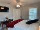 Cozy bedroom featuring a ceiling fan, window with blinds, and tiled floor at 404 Elder St # 230, Englewood, FL 34223