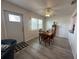 Dining room featuring wood floors, natural light, and a ceiling fan at 404 Elder St # 230, Englewood, FL 34223