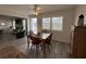 Dining room with wood floors and view into the living room at 404 Elder St # 230, Englewood, FL 34223