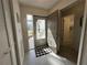 Inviting entryway with tiled flooring, storm door and ample natural light at 404 Elder St # 230, Englewood, FL 34223