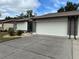 Exterior of home with two car garage and concrete driveway at 404 Elder St # 230, Englewood, FL 34223