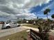 Well-manicured exterior and landscaping view with golf cart parking sign at 404 Elder St # 230, Englewood, FL 34223