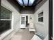View of screened front porch with stylish decor and lots of natural light at 404 Elder St # 230, Englewood, FL 34223