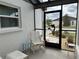 View of screened front porch with stylish decor and lots of natural light at 404 Elder St # 230, Englewood, FL 34223