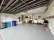 Open garage features laundry area, water heater, epoxy flooring, and storage solutions at 404 Elder St # 230, Englewood, FL 34223