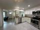 Kitchen showcases stainless appliances, granite counters and a view into the adjoining living spaces at 404 Elder St # 230, Englewood, FL 34223