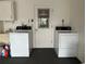 Bright laundry area with a washer, dryer, utility sink, and plenty of storage at 404 Elder St # 230, Englewood, FL 34223