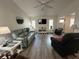 Bright living room with plank flooring, a ceiling fan, and ample seating space at 404 Elder St # 230, Englewood, FL 34223