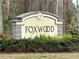 Foxwood community sign surrounded by lush, green landscaping at 404 Elder St # 230, Englewood, FL 34223