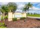 Osprey Cove community sign on a sunny day surrounded by mulch and green landscaping at 4301 Whispering Oaks Dr, North Port, FL 34287