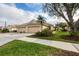 Well-maintained home featuring a three car garage, lush landscaping and a welcoming driveway at 4301 Whispering Oaks Dr, North Port, FL 34287
