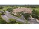 Exterior aerial view of the clubhouse with parking and lush landscaping at 4301 Whispering Oaks Dr, North Port, FL 34287