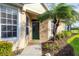 Front entrance featuring a well-manicured lawn, a beautiful walkway, and lush landscaping at 4301 Whispering Oaks Dr, North Port, FL 34287
