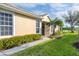 Charming home exterior with a well-manicured lawn, lovely landscaping and a welcoming entryway at 4301 Whispering Oaks Dr, North Port, FL 34287