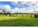 Scenic view of the lush green golf course showcasing manicured landscaping at 4301 Whispering Oaks Dr, North Port, FL 34287