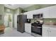 A bright kitchen with stainless steel appliances, white cabinets, and an adjacent laundry area at 4301 Whispering Oaks Dr, North Port, FL 34287
