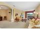 Bright living room with large windows, archways, column, floral furniture, and comfortable seating at 4301 Whispering Oaks Dr, North Port, FL 34287