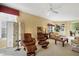 Bright living room features plush seating, a decorative screen, and an abundance of natural light at 4301 Whispering Oaks Dr, North Port, FL 34287