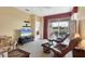 Comfortable living room featuring plush seating and a sliding glass door leading to the outdoor patio at 4301 Whispering Oaks Dr, North Port, FL 34287