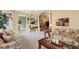 An open-concept living room with an arched doorway and plush, floral seating arrangements at 4301 Whispering Oaks Dr, North Port, FL 34287