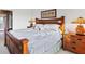 Spacious primary bedroom featuring a wooden bed frame, side tables, and tasteful decor at 4301 Whispering Oaks Dr, North Port, FL 34287
