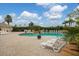 Resort-style pool with lounge chairs and tropical landscaping, perfect for relaxation at 4301 Whispering Oaks Dr, North Port, FL 34287